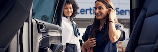 CarBravo Certified Service Team Member Assisting Customer Sitting in her Vehicle