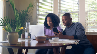 Women and men looking at a laptop