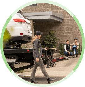 woman walking around a towing car
