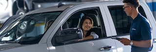 CarBravo Certified Service Team Member Assisting Customer Sitting in her Vehicle