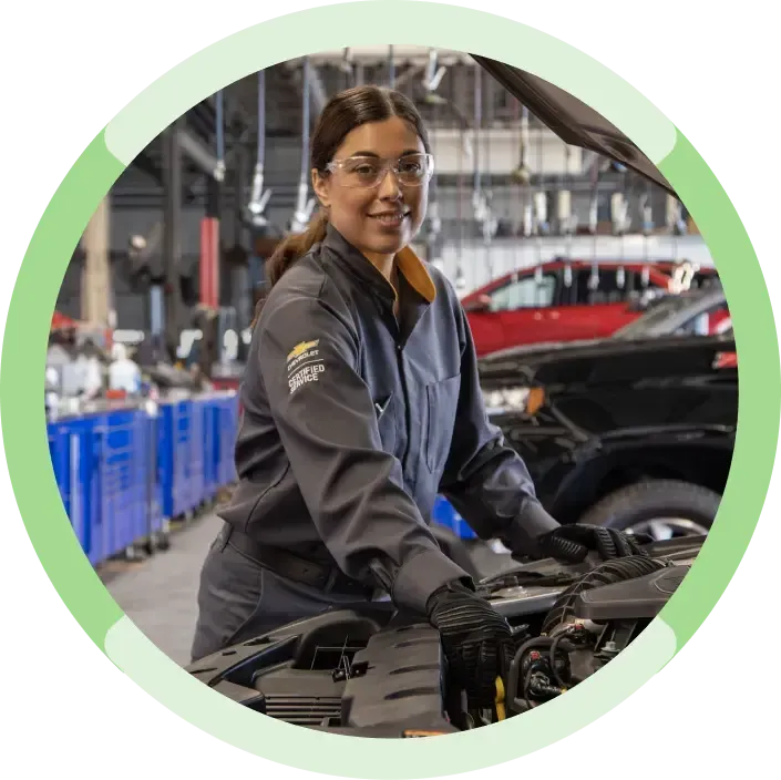 An Expert Certified Service Technician Smiling While Working on a Vehicle