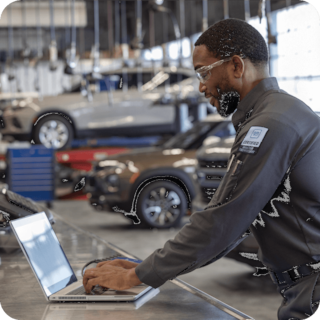 CarBravo Certified Service Technician Using a Laptop