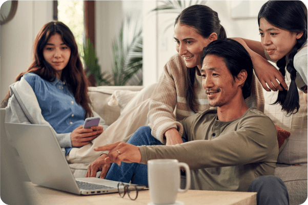 family looking at laptop