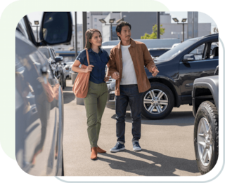 Couple in the parking lot browsing the vehicle options